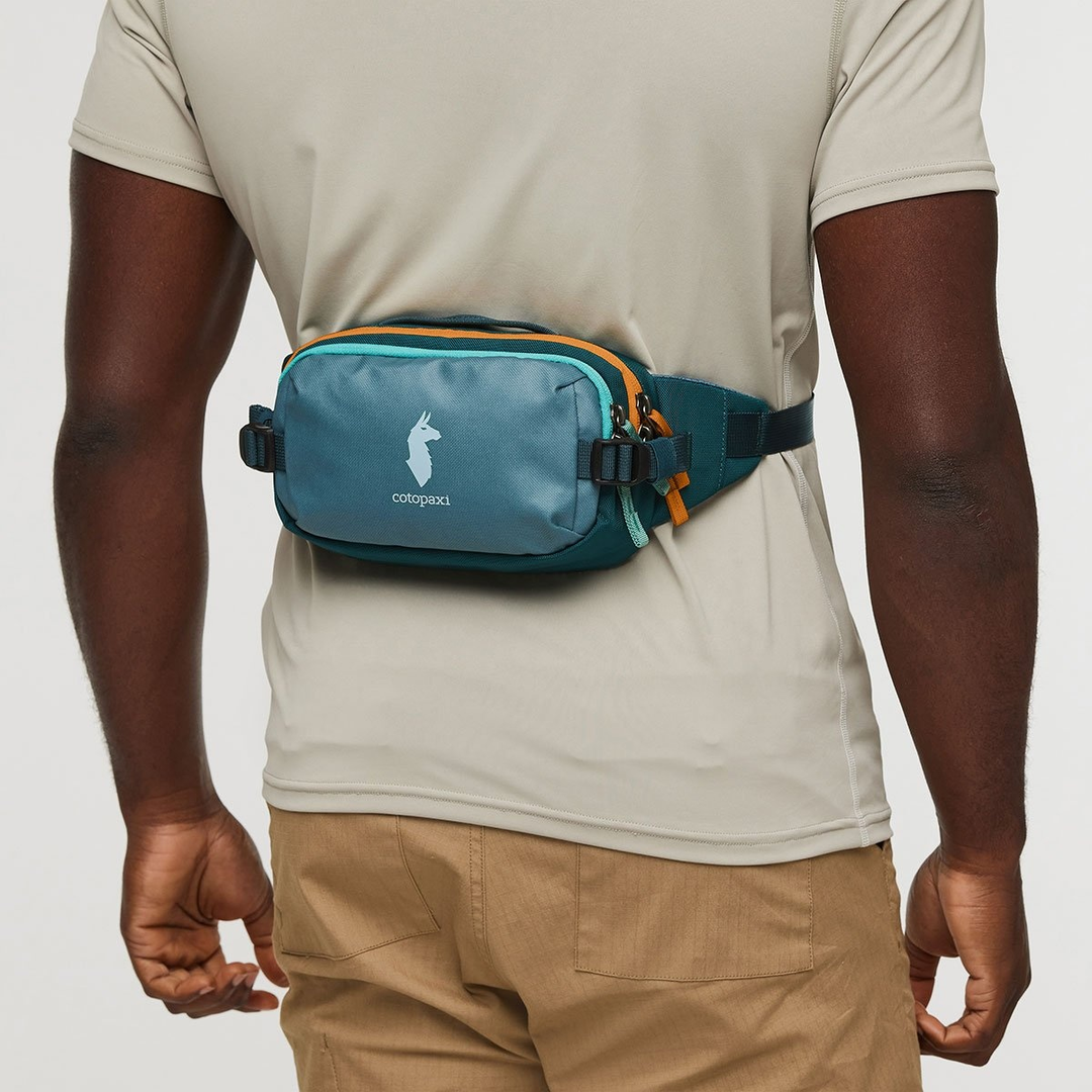 Allpa X 1.5L Hip Pack worn by a person, featuring easy access, side-release compression buckles, and adjustable strap.