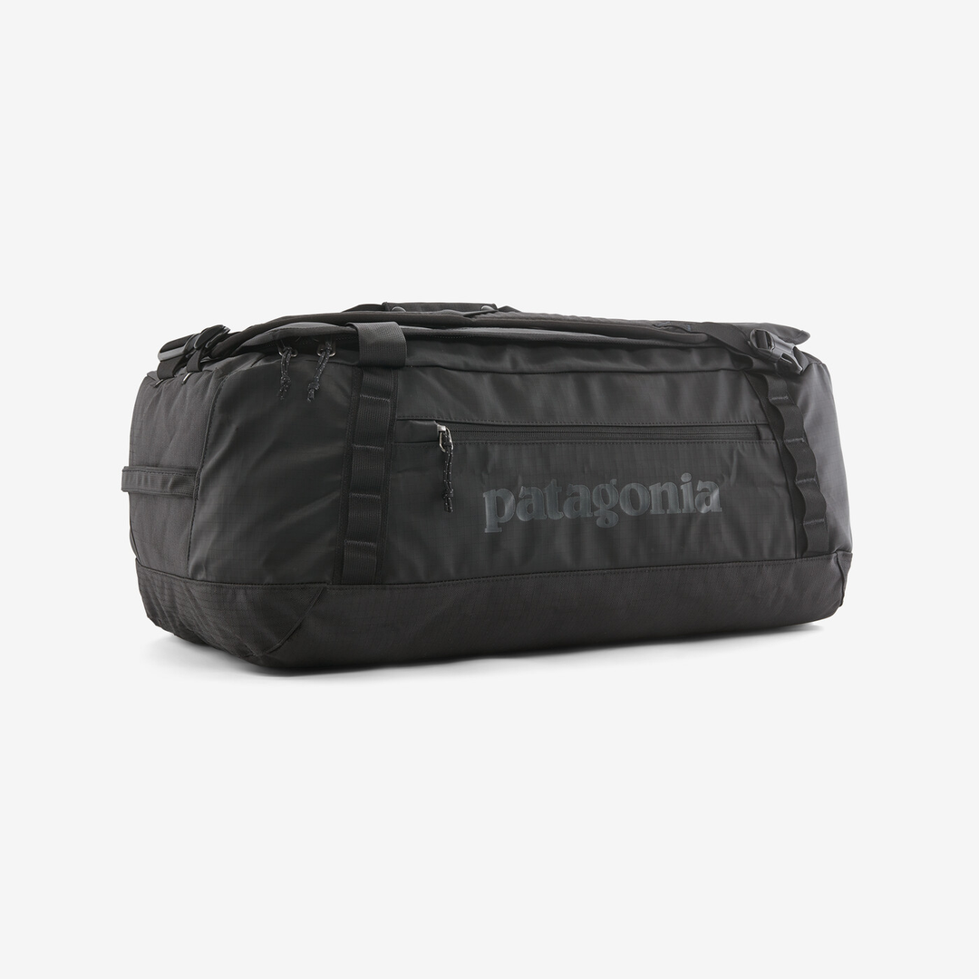 Black Hole Duffel 55L bag in black on white background, robust and travel-ready.