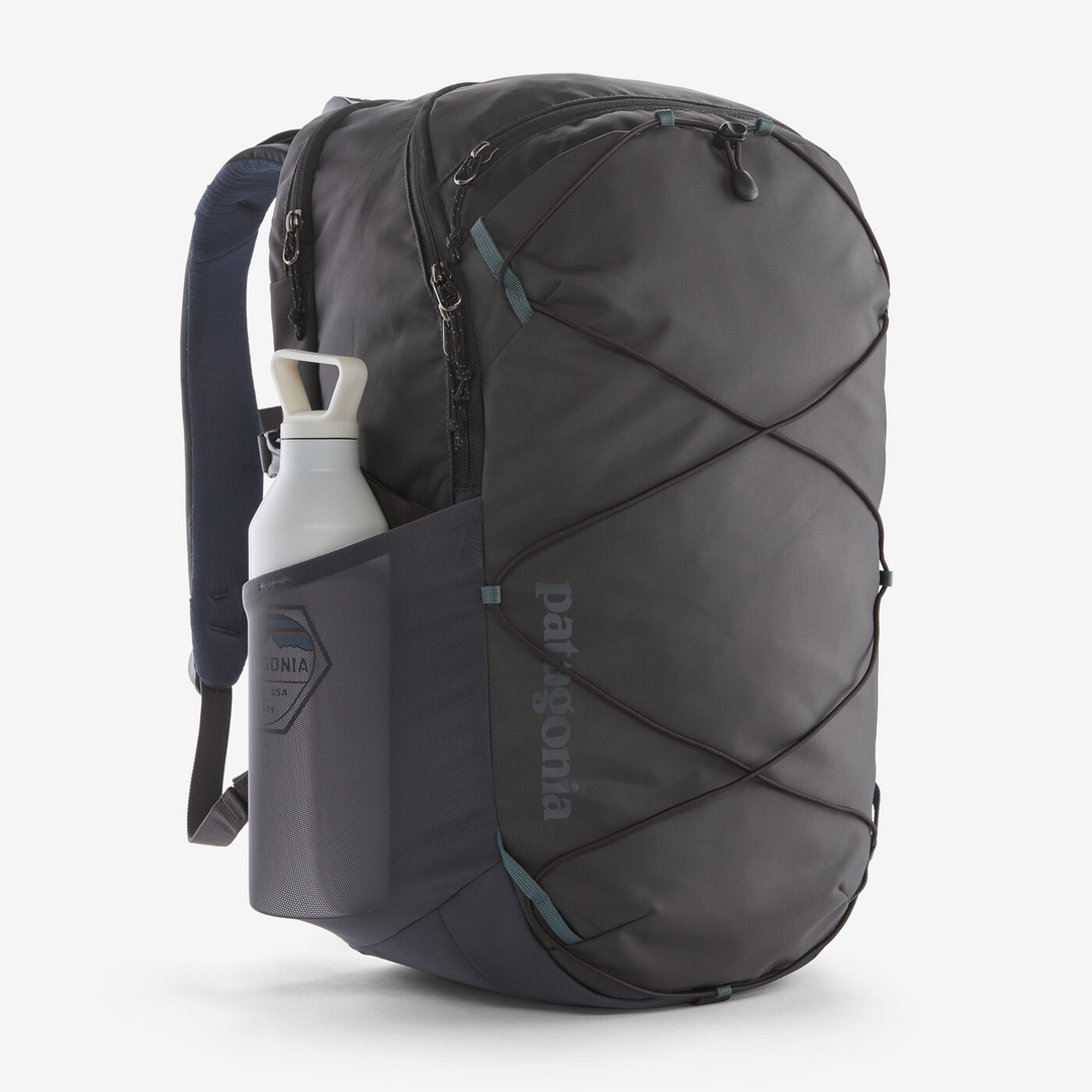 Refugio Day Pack 30L in recycled polyester features multiple compartments, laptop sleeve, and hydration system loop for everyday use and outdoor activities.