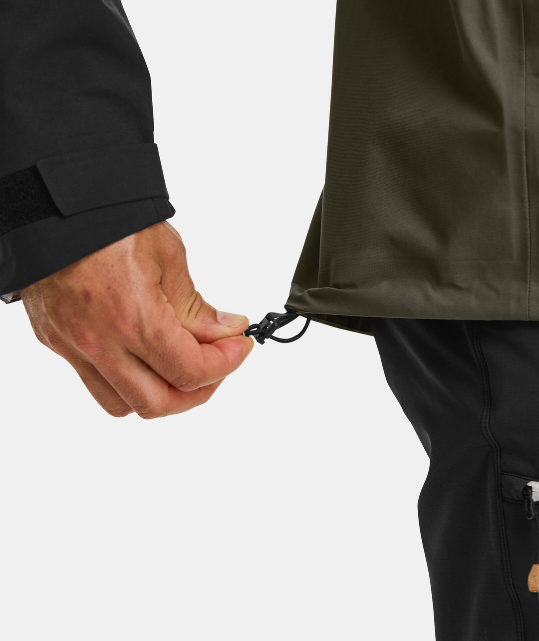 Adjustable hem on the SECEDA 3L Jacket, showcasing durable and versatile design for mountain performance.