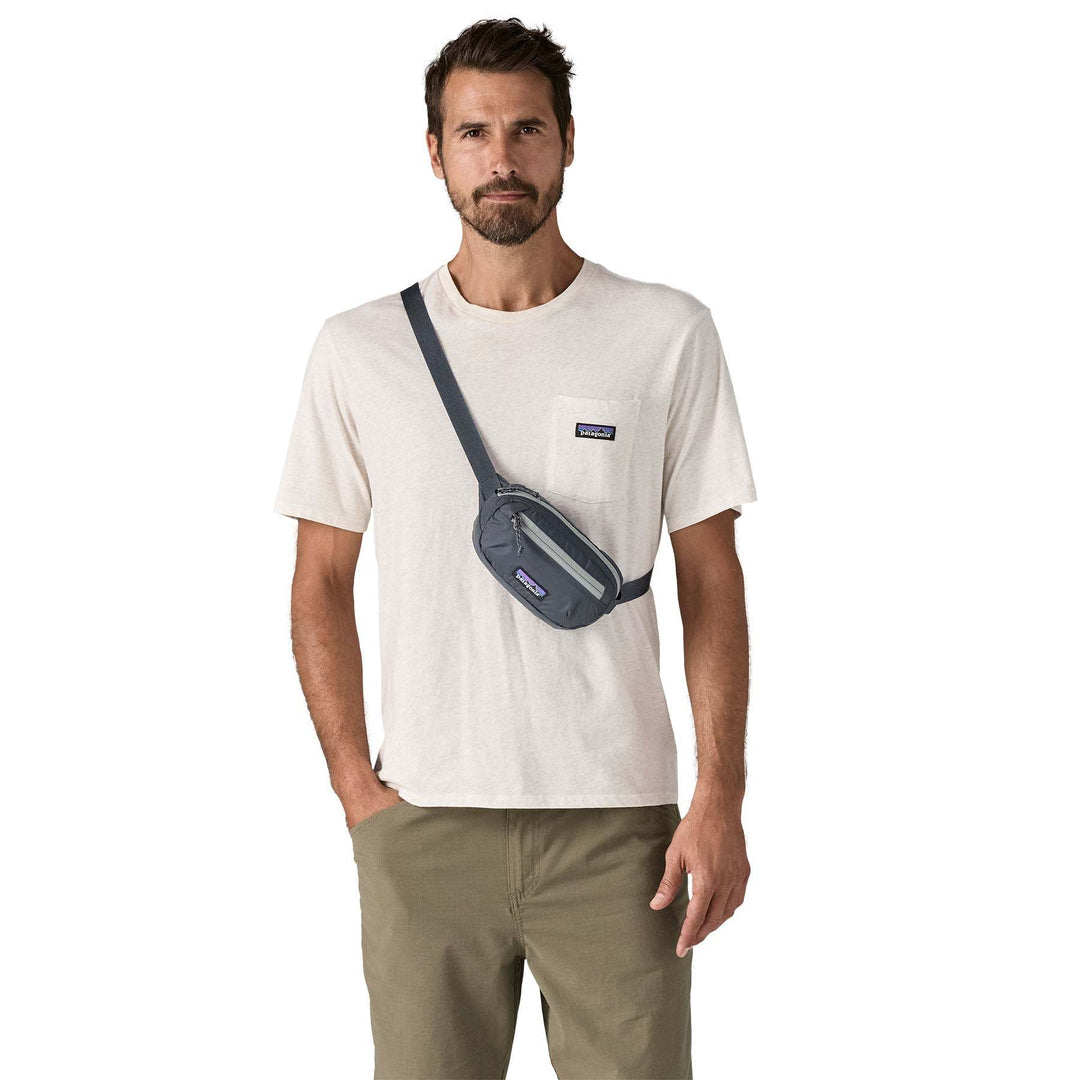 Terravia Mini Hip Pack worn crossbody by a man wearing a casual outfit, showcasing its lightweight and compressible design.