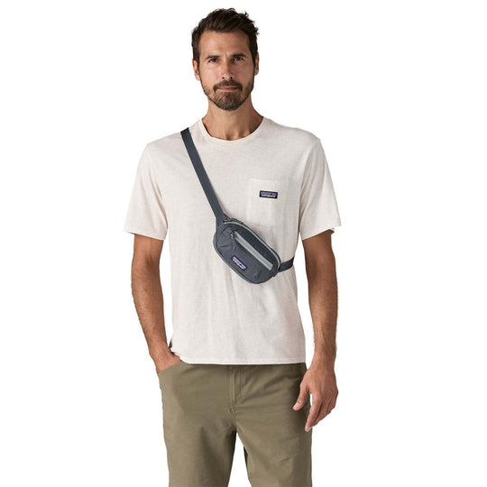 Terravia Mini Hip Pack worn crossbody by a man wearing a casual outfit, showcasing its lightweight and compressible design.