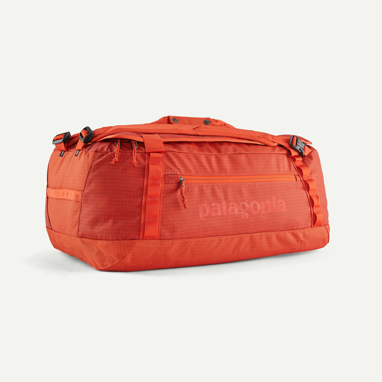 Orange Black Hole Duffel 55L with durable recycled fabric and removable straps.