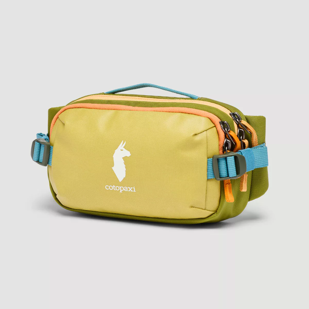 Allpa X 1.5L hip pack in green with front buckle, top handle, and dual-zippered main compartment.