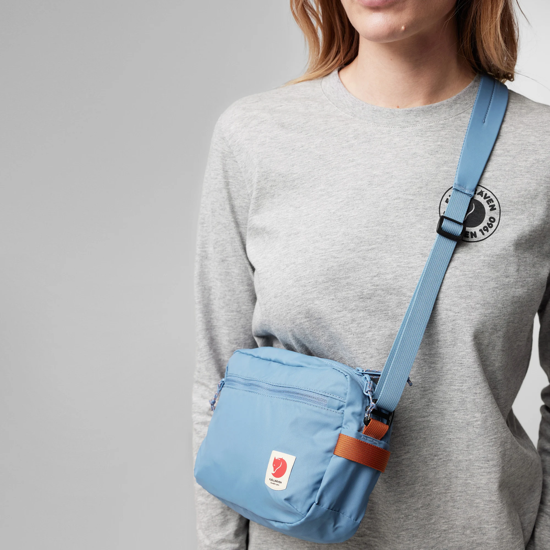 High Coast Crossbody bag in blue worn crossbody, adjustable and removable strap, lightweight design.