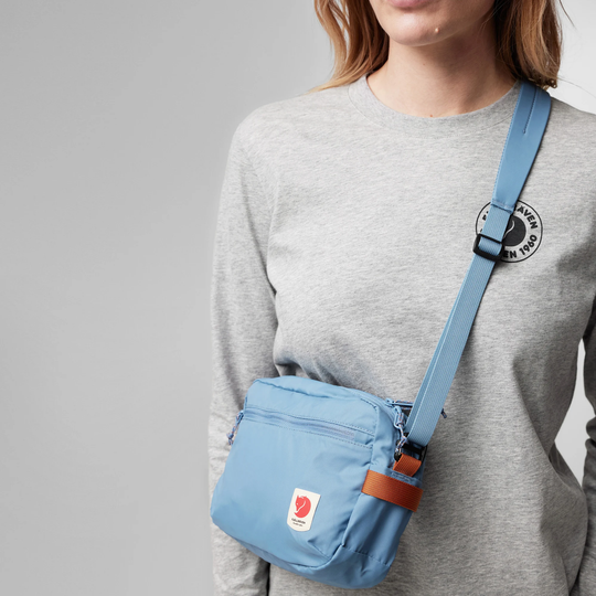High Coast Crossbody bag in blue worn crossbody, adjustable and removable strap, lightweight design.