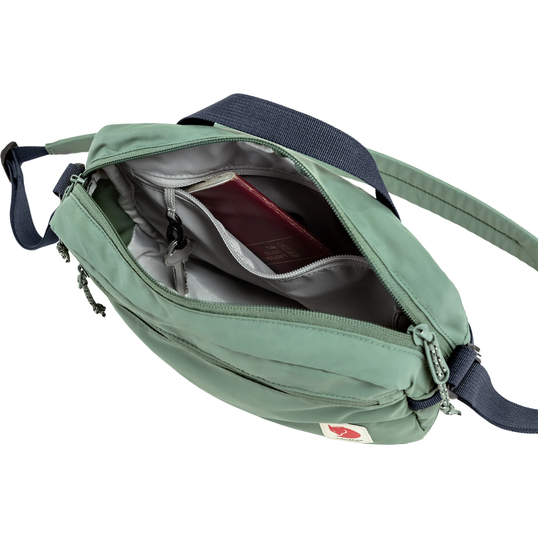 High Coast Crossbody bag in green, showcasing adjustable strap and organized interior pockets.