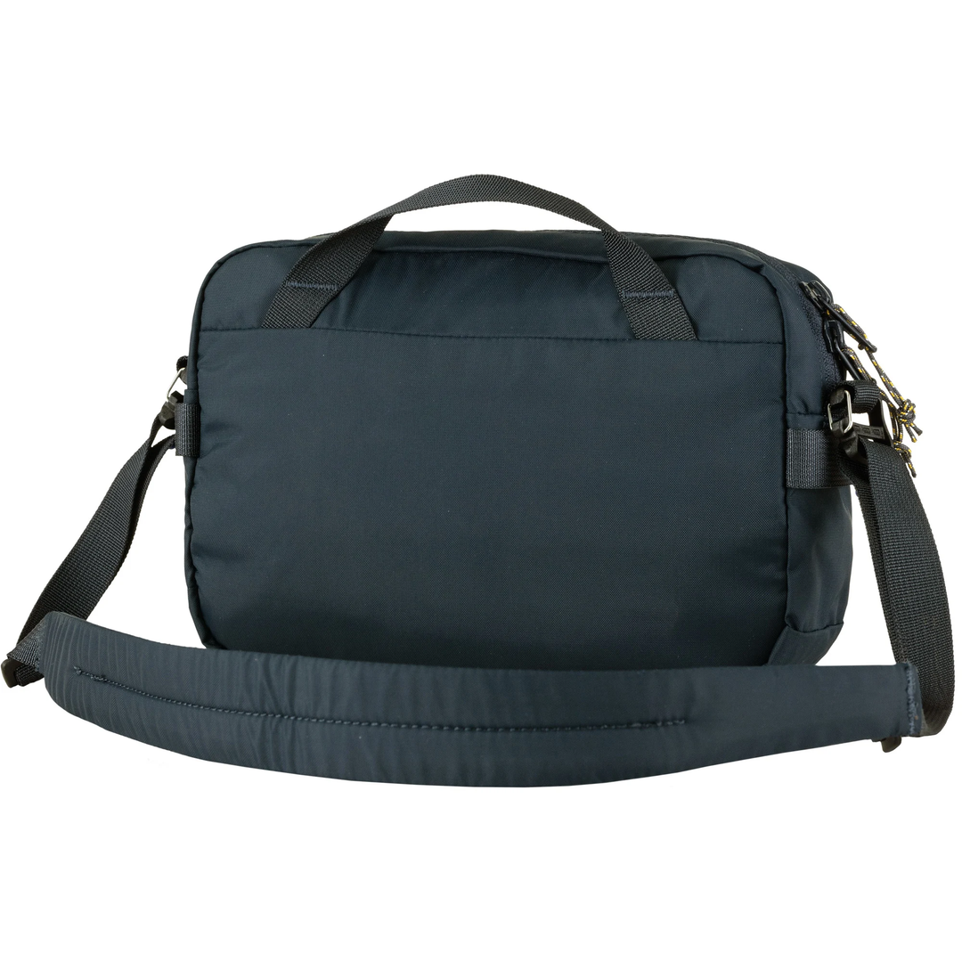 High Coast Crossbody bag in black with adjustable padded strap, front zipper pocket, side gear loops.