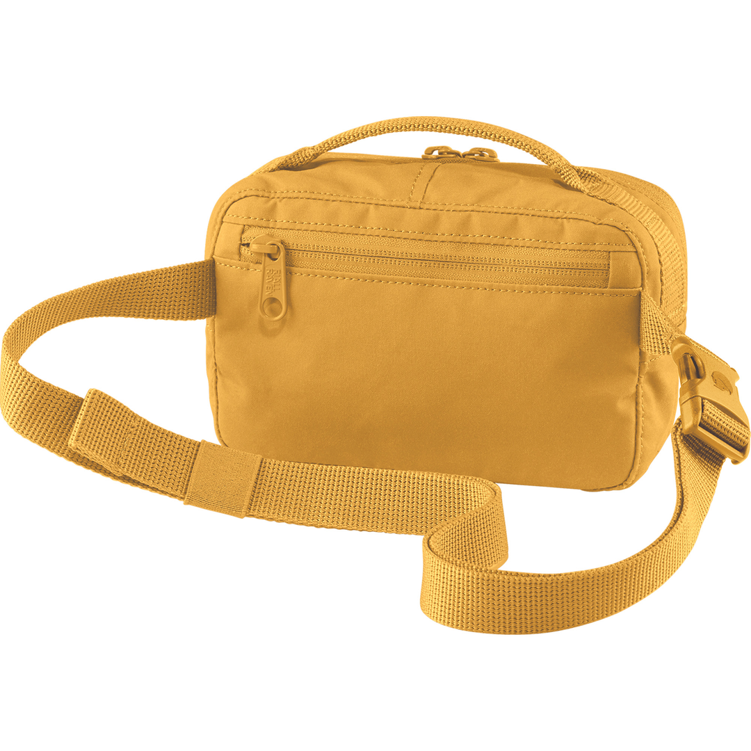 Kånken Hip Pack yellow with adjustable strap and multiple zippered pockets.