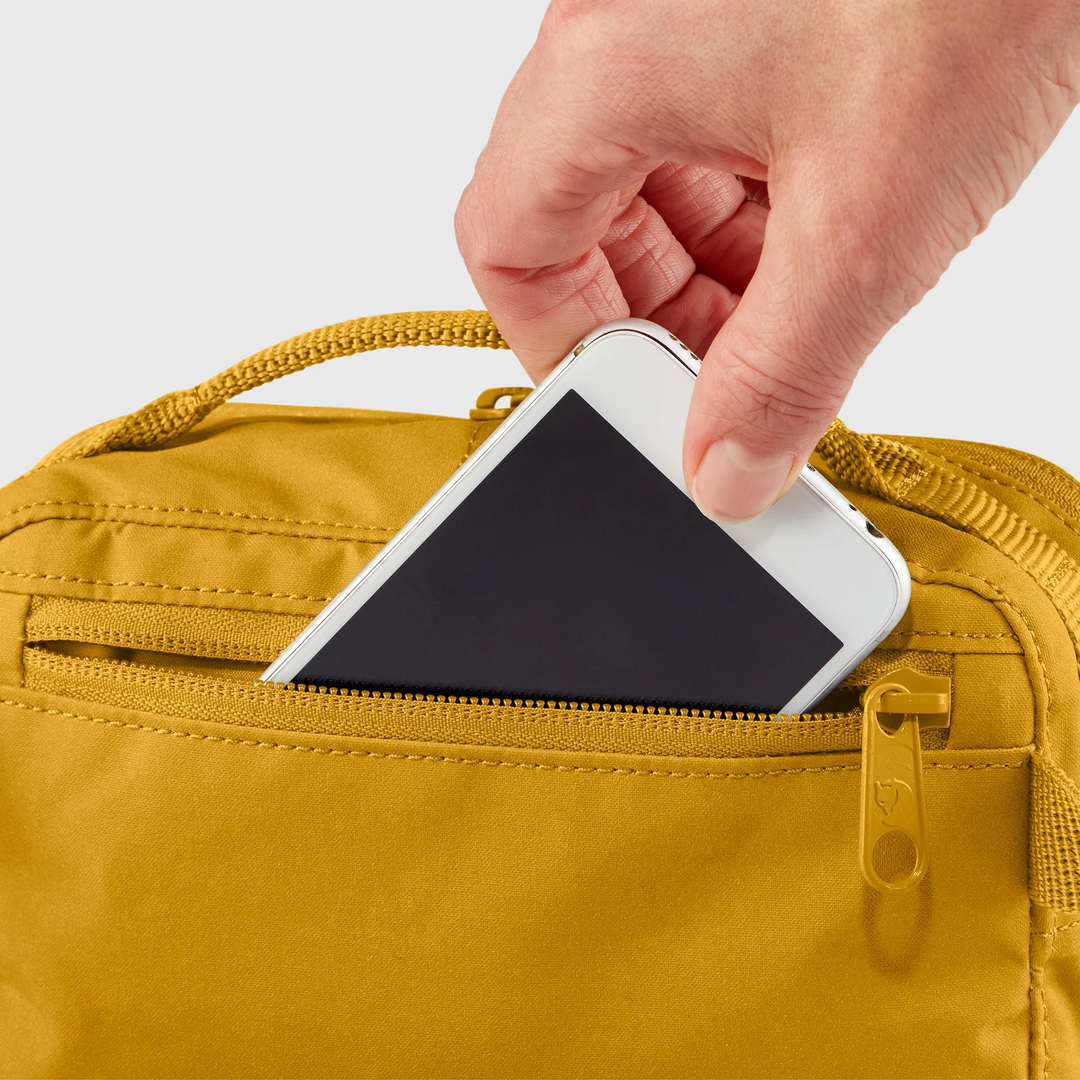 Kånken Hip Pack with phone in zippered pocket.