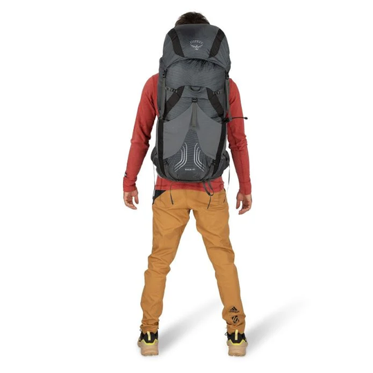 Exos 48 backpacker wearing ultralight, ventilated hiking backpack, featuring adjustable AirSpeed suspension and multiple pockets.