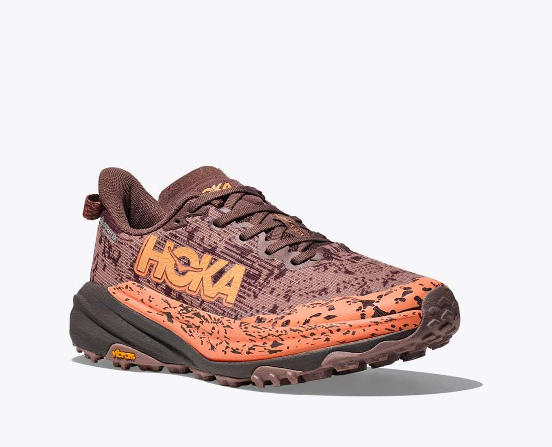 Trail running shoe, Speedgoat 6 GTX, with waterproof GORE-TEX, Vibram Megagrip sole, in brown and orange tones.