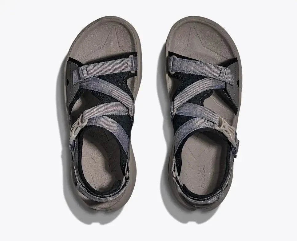 HOKA Infini Hike Tc open-toe sandal with adjustable straps, Vibram Megagrip sole, and Ariaprene upper for hiking