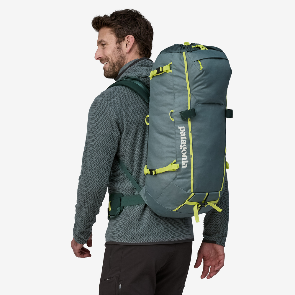 Man wearing blue Ascensionist 35L backpack for climbing.