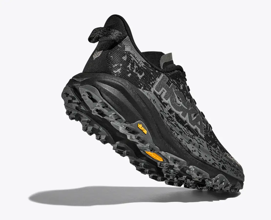 Speedgoat 6 GTX trail shoe with GORE-TEX and Vibram Megagrip sole in black.
