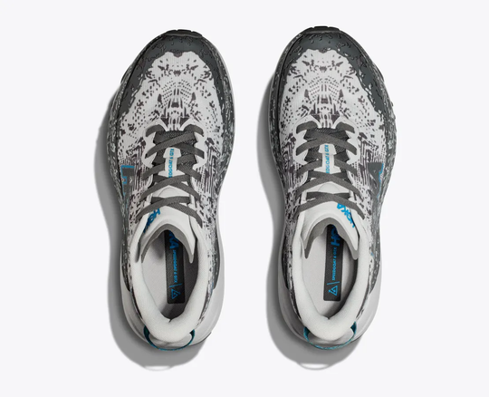 Trail running shoes with a grey and white pattern, featuring GORE-TEX and Vibram Megagrip soles.