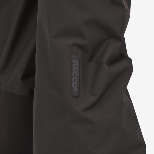 RECCO reflector on black Powder Town Pants for enhanced safety and searchability.