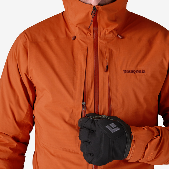 M10 Storm Jkt in orange, waterproof design with adjustable hood and front zip.