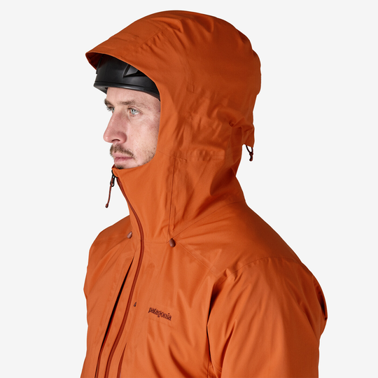 Alpinism jacket M10 Storm Jkt, orange color, adjustable hood, helmet-compatible.