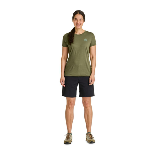 Woman wearing 120 Cool Tec Mtn Stripe T-shirt in green, ideal for high-intensity mountain activities.
