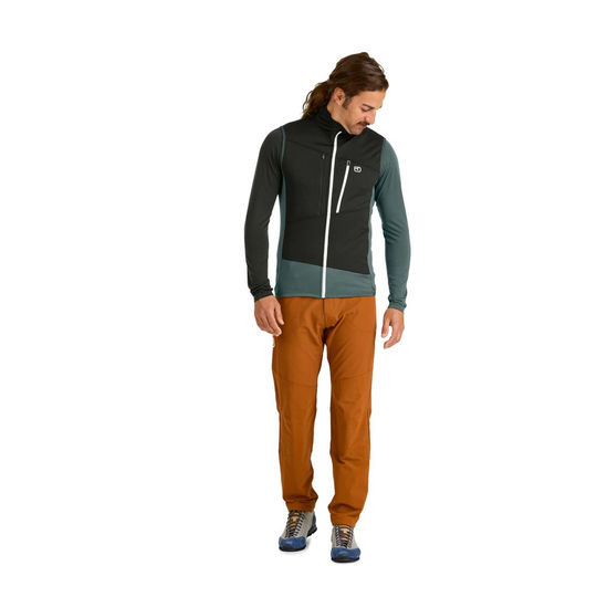 Fleece Grid Vest M for alpine tours, men wearing vest with zip and chest pockets, brown pants, breathable merino material.