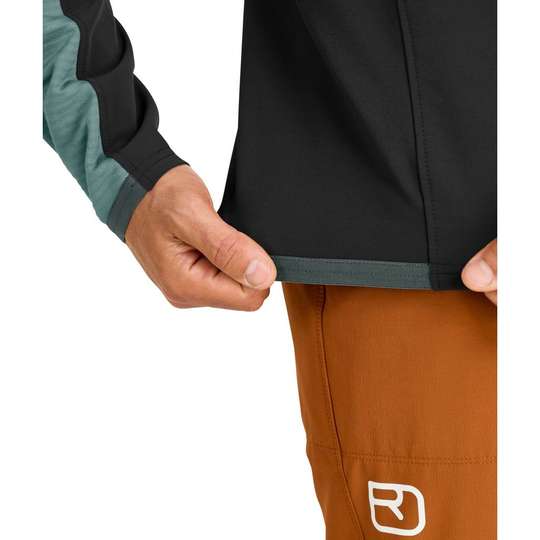 Fleece Rib Jacket M with dual-colored sleeve detail, worn over orange climbing pants.