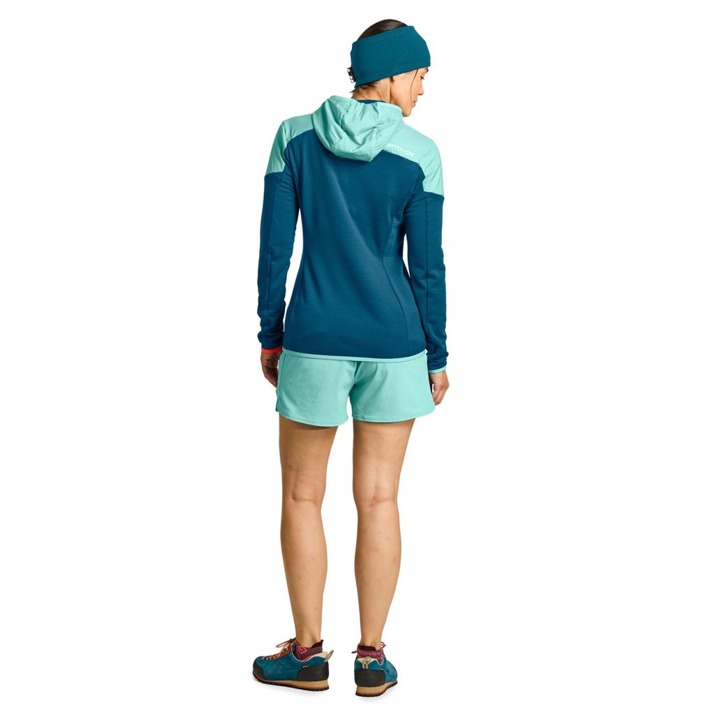 Ladiz Hybrid Jacket W in blue, featuring windproof inserts and Merino wool for alpine use.