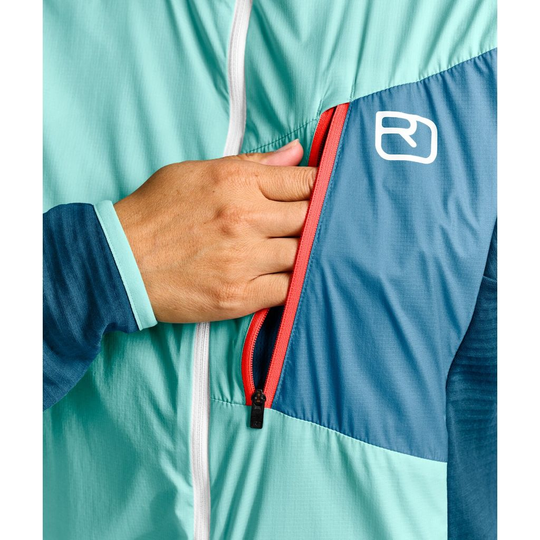 Ladiz Hybrid Jacket W with windproof inserts and Merino fleece, featuring chest pocket and elastic cuffs.