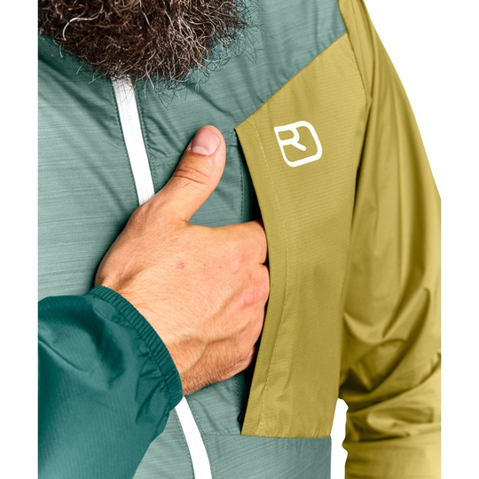 Ultralight windbreaker jacket with Merino wool blend and ergonomic design, featuring chest pocket.
