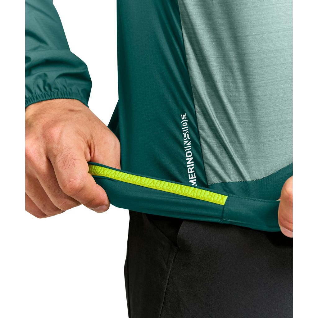 Ultralight men's windbreaker jacket detail, featuring elasticized hem with Merino wool blend, ideal for alpine activities.