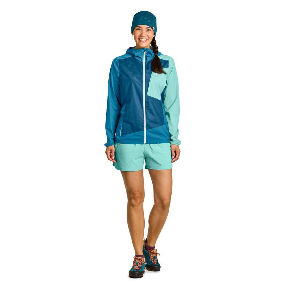 Lightweight women's windbreaker jacket with Merino wool, blue color, durable and compact for alpine activities.