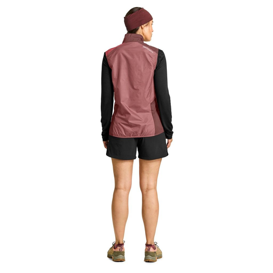 Women's windbreaker vest, lightweight, compact, maroon color, ergonomic fit, ideal for alpine use.