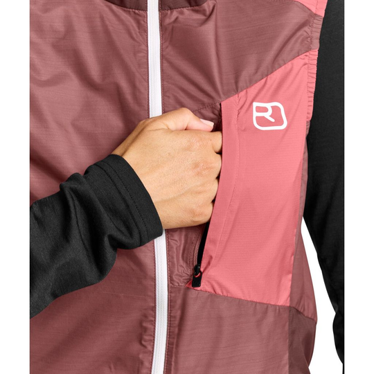 Windbreaker vest with chest pocket, lightweight, maroon and pink color, ergonomic design for alpine hiking.