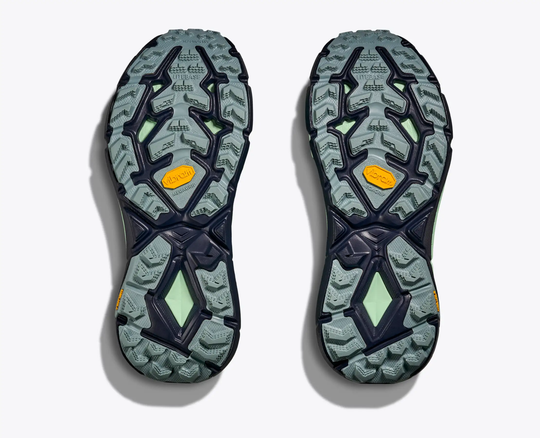 Trail running shoe soles of Mafate Speed 4 featuring Vibram MegaGrip technology.