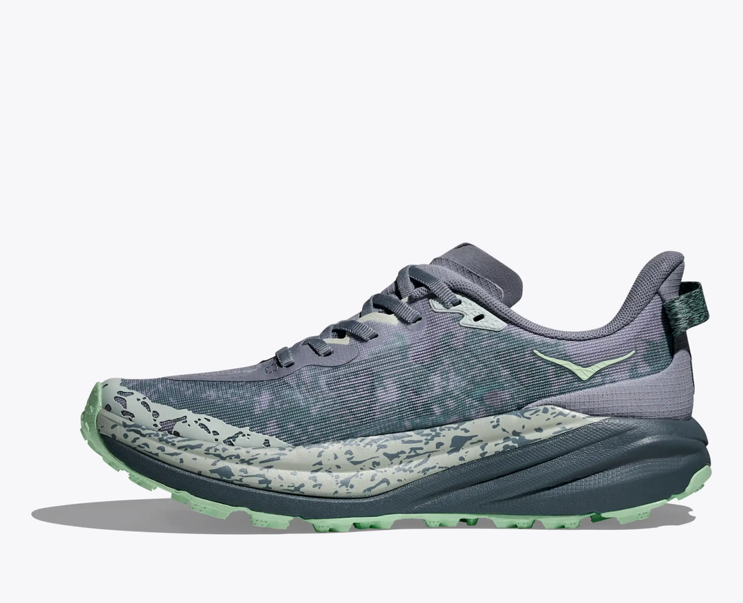 Trail running shoe "W Speedgoat 6" in gray and mint, featuring breathable upper and aggressive traction.