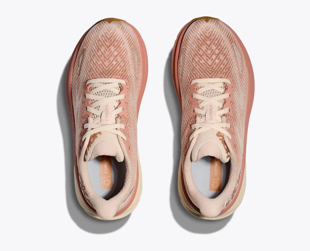 Clifton 9 running shoes, lightweight design in a pink and beige colorway with breathable mesh upper and streamlined laces.