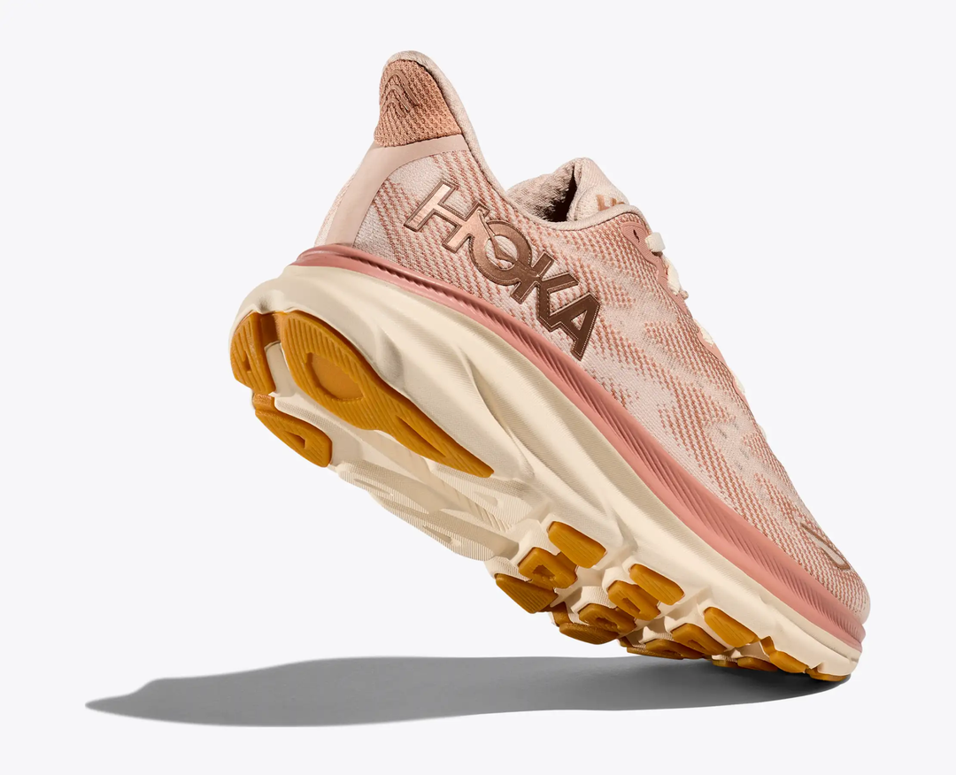 Clifton 9 running shoe in pink, lightweight with cushioned sole and eco-friendly design.