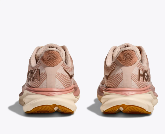 Clifton 9 running shoes in light pink featuring breathable mesh and reflective heel panel.