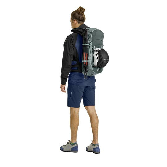 Versatile Traverse 30 backpack for alpine adventures, worn by male hiker.