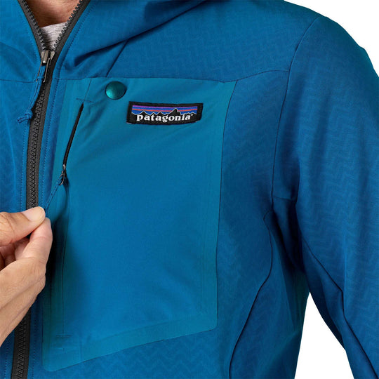 W's R1 Crossstrata Hoody in blue with chest pocket and zipper detail.