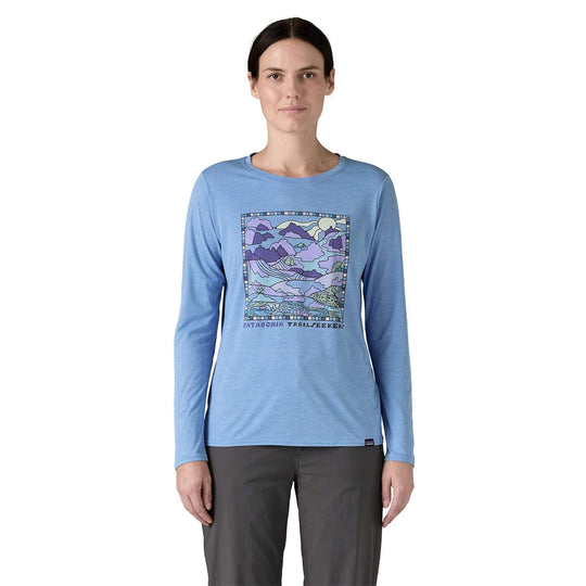 W's L/S Cap Cool Daily Graphic Shirt, long-sleeve blue shirt with artistic front design, featuring moisture-wicking and odor control technology, perfect for trail or water activities.