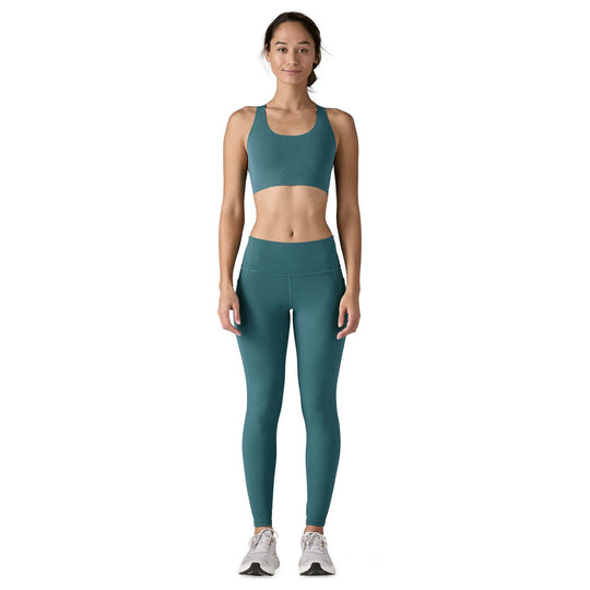 Woman wearing W's Live Simply Bra, designed for low-impact activities with minimalist support, featuring a racerback and smooth recycled fabric.