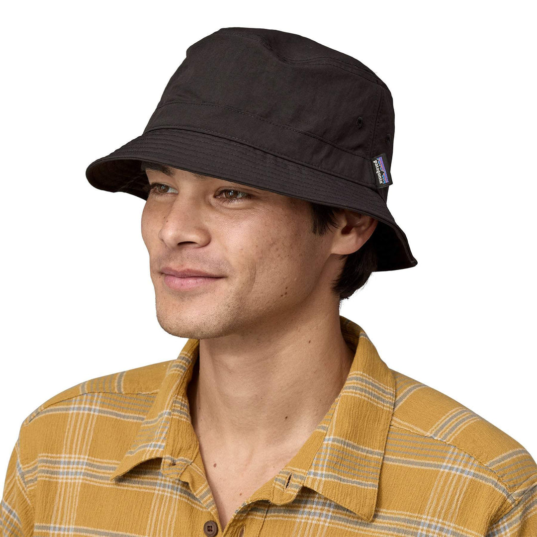 Breathable and compressible black Wavefarer bucket hat made from recycled nylon with water-repellent finish.