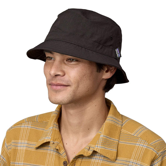 Breathable and compressible black Wavefarer bucket hat made from recycled nylon with water-repellent finish.