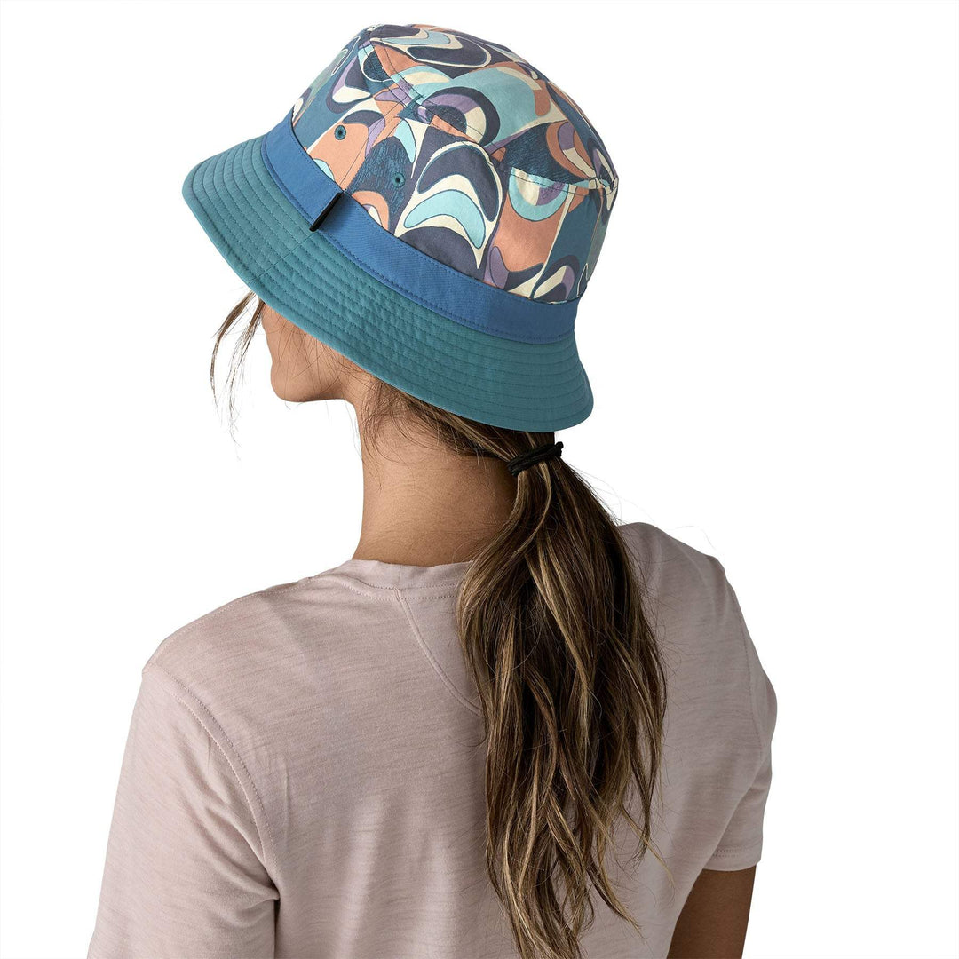 Wavefarer Bucket Hat in colorful design worn by a person, made from recycled NetPlus® nylon, features compressibility and water-repellent finish.