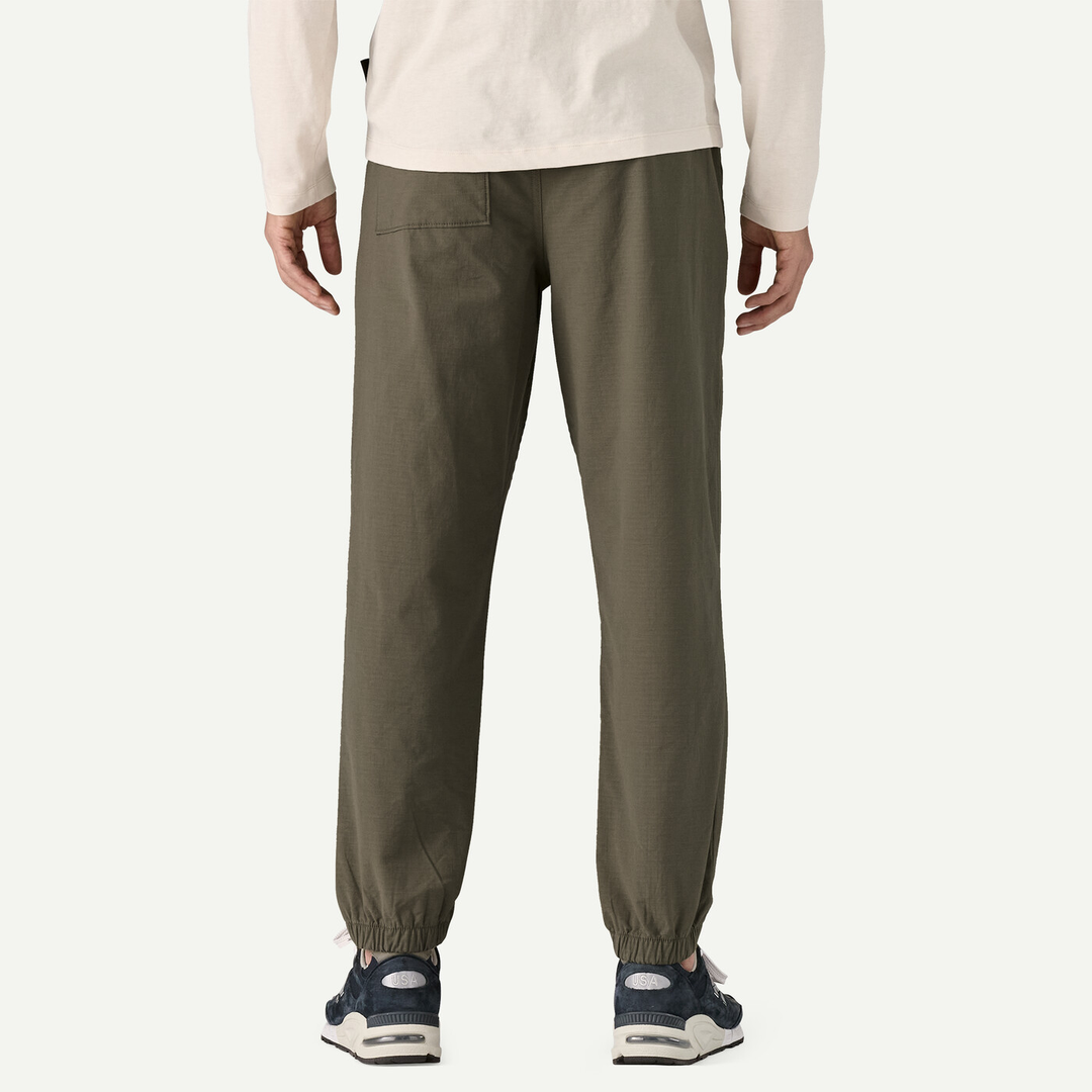 M's Nomader Joggers, comfortable stretchy khaki pants, back view, elastic cuffs, worn by male model.
