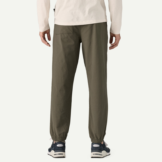 M's Nomader Joggers, comfortable stretchy khaki pants, back view, elastic cuffs, worn by male model.