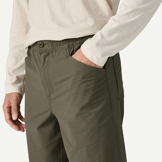 M's Nomader Joggers, durable stretch fabric, elastic waistband, olive green, front pockets, zipper closure.
