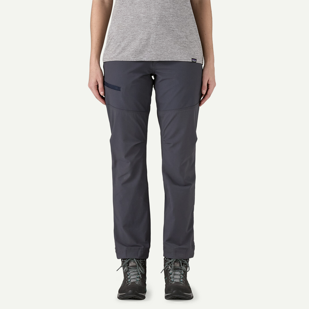 Women's Terravia Peak Pants in grey, designed for outdoor adventures with reinforced knees, adjustable waist, and multiple zippered pockets.