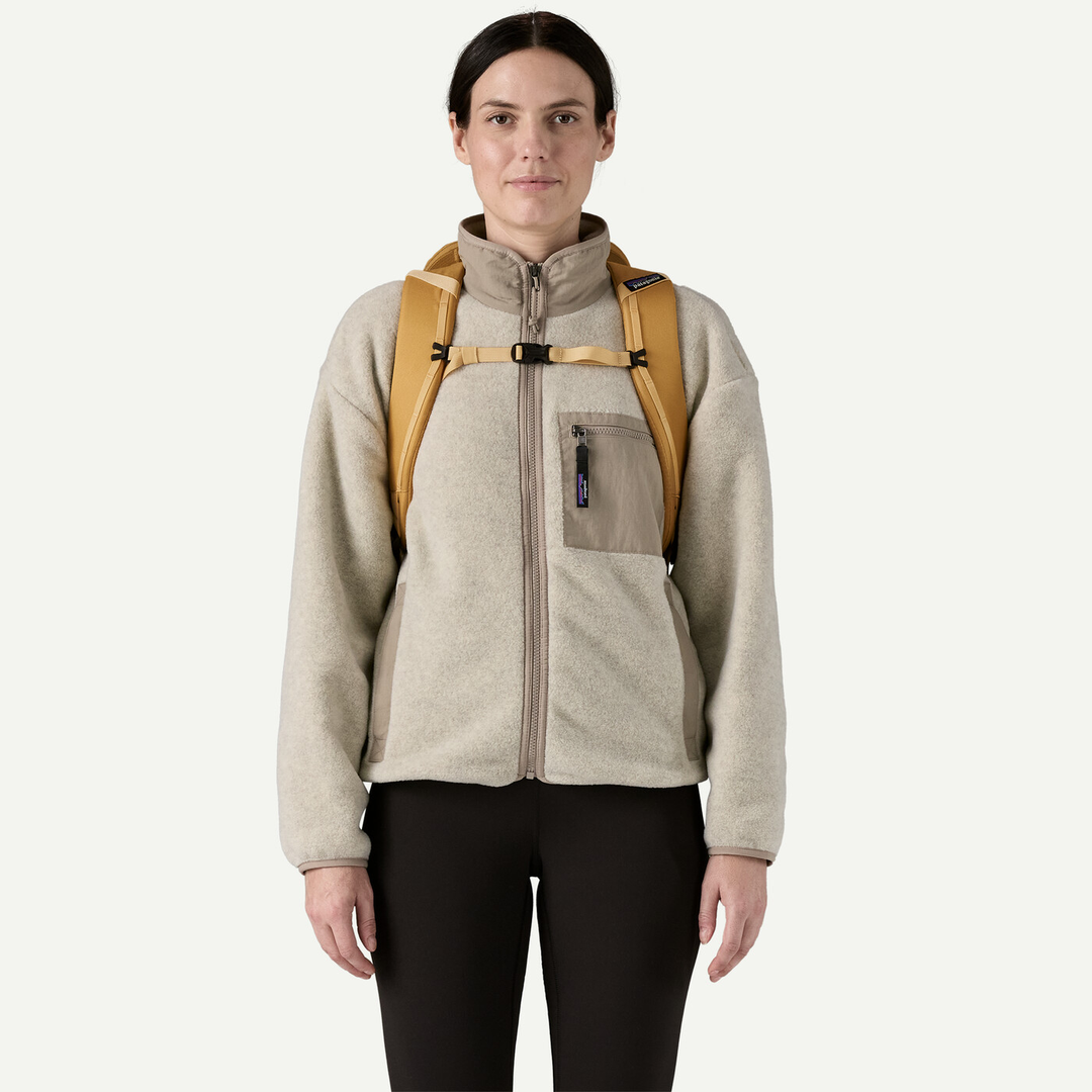 Black Hole Pack 32L backpack worn by person, emphasizing its durability and eco-friendly design.